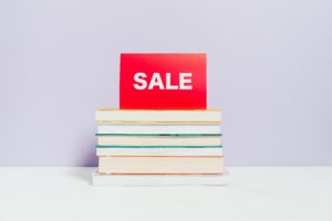 Sale sign on stack of books